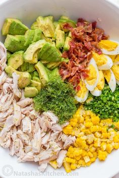 a bowl filled with eggs, avocado, corn and other foodstuffs