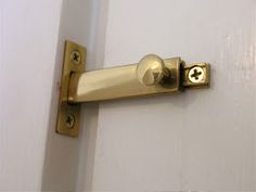 a close up of a door handle on a white door