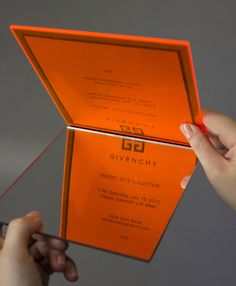 a person holding an orange box with the inside open