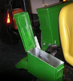 two green and yellow chairs sitting next to each other in front of a truck with the door open