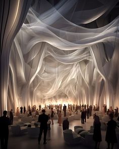 an artisticly designed lobby with white drapes covering the ceiling and people walking around