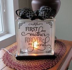 a glass block with the words'first day mother forever my friend'on it