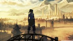 a person standing on top of a bridge looking at the city in the distance with mountains behind them