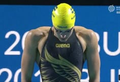 a man wearing a yellow helmet and swimming suit