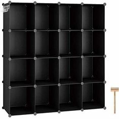 a black bookcase with six shelves and two small stools on the floor next to it