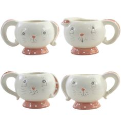 four ceramic mugs with cats on them