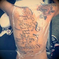 the back of a person's body covered in plastic with words written on it