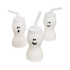 three white toothbrush holders with faces drawn on them