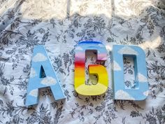 the letters are made out of wood and have been painted with different colors on them