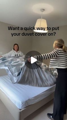 two women in striped shirts and black pants are unwrapped on a bed with the text, want a quick way to put your duvet cover on?