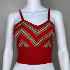 Adorable 70s red knit tank top  Brand - The Red Eye Size - Labeled Medium but it measures like a modern XS so please check all measurements to ensure fit Chest - 15.25" pit to pit, stretches to 17" Waist - 10.75" across, stretches to 15" Length - 15" (11" to underbust) Condition - Someone altered it. The straps originally connected in the back with a button/button hole but someone removed the buttons and stitched down the straps. Multicolor Fitted Retro Tank Top, Retro Red Sleeveless Tank Top, Red Cotton V-neck Crop Top, Red Sleeveless Crop Top For Spring, Red Vest Crop Top For Spring, Red Retro Spring Tank Top, Retro Red Spring Tank Top, Red Fitted Cropped Tank Top, Retro V-neck Vest Tops