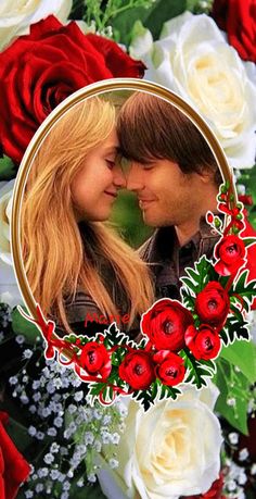 a couple is kissing in front of roses and greenery with an oval photo frame