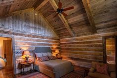 a bedroom with wood paneling and a ceiling fan