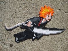 an image of a pixelated anime character laying on the ground with a knife in his hand