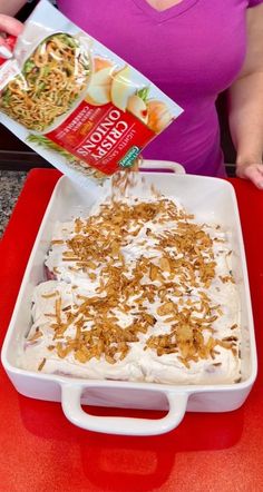 a woman is pouring rice into a casserole dish with toppings on top