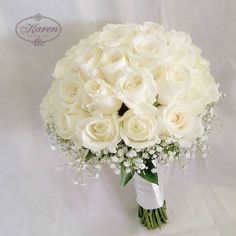 a bouquet of white roses and baby's breath