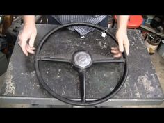 a man is working on a steering wheel