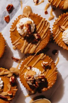 several cupcakes with frosting and nuts on top