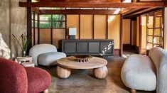 a living room with couches, chairs and a coffee table in front of a fireplace