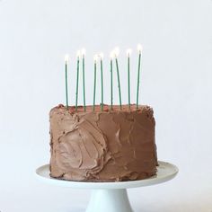 a chocolate cake with candles sticking out of it