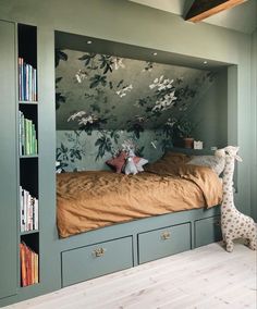 a bedroom with a bed, bookcases and stuffed animals