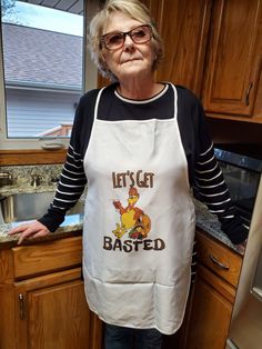 an older woman standing in a kitchen with her hands on her hips