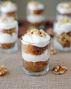 small desserts in glass cups with white frosting and walnuts on the side