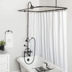 a white bathtub sitting next to a shower in a bathroom