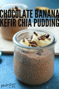 two glass jars filled with chocolate chia pudding and banana slices on a blue surface