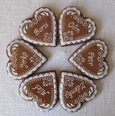 four heart shaped cookies with the words happy on them