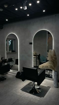 a hair salon with mirrors and lights on the walls