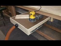 a power sander is sitting on top of a workbench