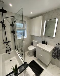 a white bathroom with black and white accessories