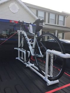 a bicycle is strapped to the back of a truck