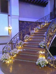 stairs decorated with flowers and lit candles