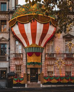 a large hot air balloon sitting in front of a building