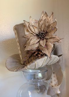 "This is a on of kind burlap tree topper top hat and or centerpiece is made and is READY TO SHIP. Use it as a Christmas tree topper or a decorative centerpiece for anywhere in your home. The top hat/centerpiece is made as follows: 🎄 The taper/body is made with light brown fabric and ivory and polka-dot burlap fabric. 🎄Decorated with a large handcrafted burlap glittered poinsettia, handcrafted glittered leaf's, glittered pinecones and a glittered swirl pick. 🎄The brim is made with 2.5\" wide l Burlap Tree Topper, Rustic Tree Topper, Top Hat Centerpieces, Art Hats, Burlap Tree, Burlap Trees, Room Box Miniatures, Easy Fall Decor, Brown Ribbon