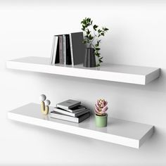 two white floating shelves with plants and books