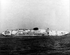 an airplane is sitting in the middle of the water on top of a ship that has been wrecked