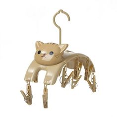 a toy cat hanging from a hook on a white background