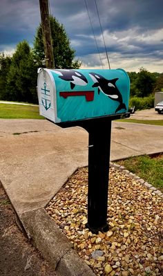 a mailbox with an orca whale painted on it