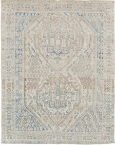 an antique rug with blue and beige colors