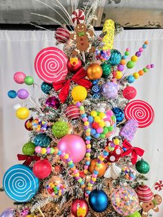 a colorful christmas tree decorated with candy and lollipops