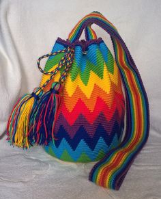 a multicolored bag with tassels on it