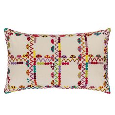 a white pillow with multicolored geometric designs on the front and back, sitting on a white background