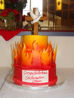 a cake that has been decorated to look like a cross with flames on it and the words congratulations contemplation jesus