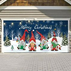 a garage door decorated with christmas gnomes and snowman's in the driveway