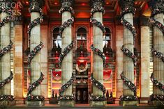 an ornate building decorated for christmas with wreaths