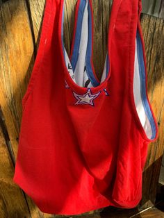 a red bag hanging on a wooden wall