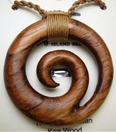 a wooden necklace with a spiral design on it